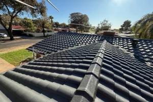 Restored concrete tile roof with ridge capping